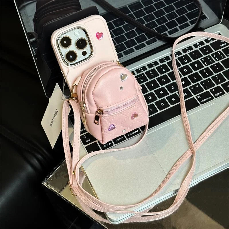 Crossbody wallet phone case for ApplePhone in white, black, or pink with removable shoulder strap