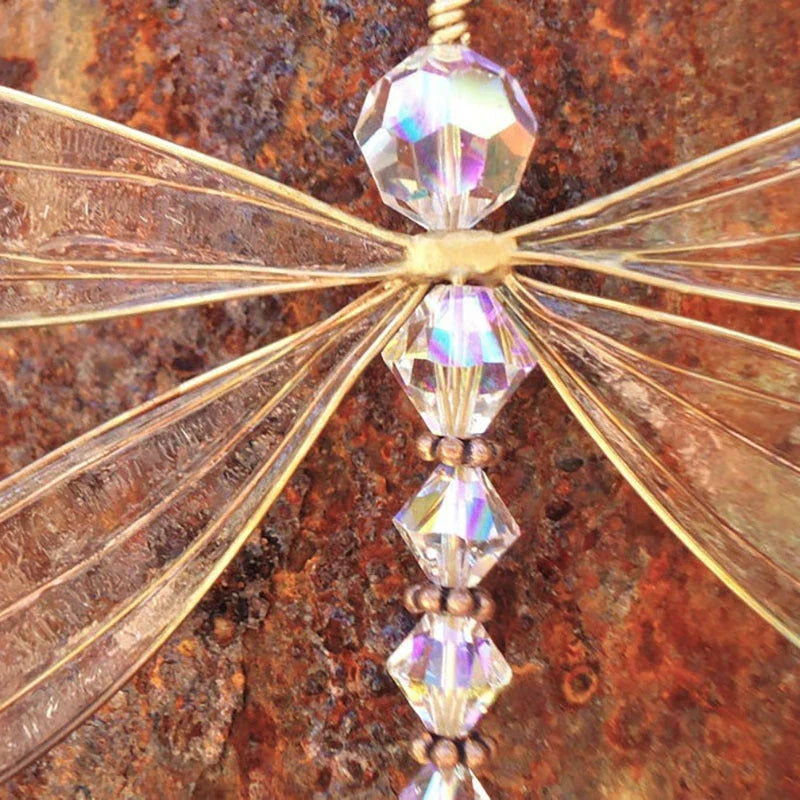 Dragonfly-shaped crystal suncatcher that creates a vibrant rainbow display when exposed to sunlight, perfect for garden, wedding and home decor