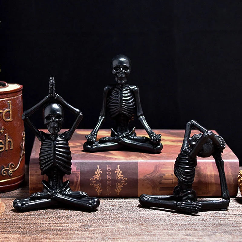 Haunting Halloween desktop ornaments, featuring intricate resin skulls and skeletons in black and vintage white finishes