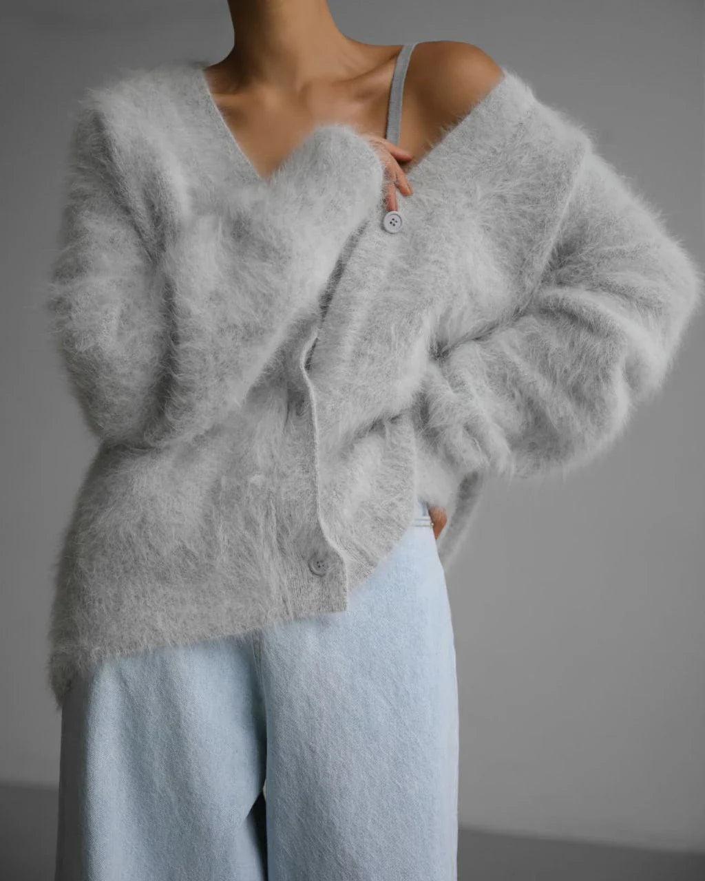 A stylish loose knit cardigan in a variety of colors, featuring a v-neck design and single-breasted closure for a flattering, relaxed fit.