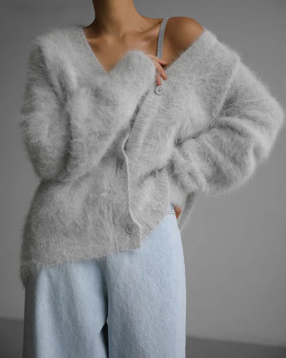 A stylish loose knit cardigan in a variety of colors, featuring a v-neck design and single-breasted closure for a flattering, relaxed fit.