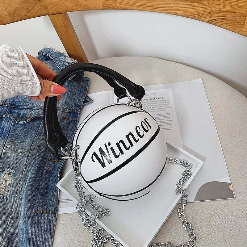 Basketball-shaped handbag in pink, white, black, or brown with adjustable chain shoulder strap