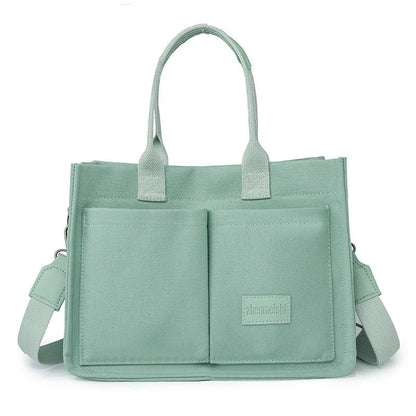 Stylish and durable canvas tote bag with multiple pockets for everyday use