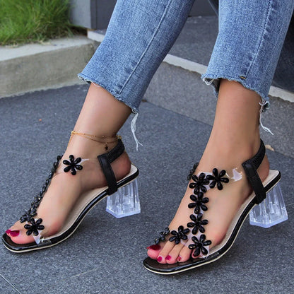 Stylish floral sandals with transparent high square heels for women, available in black and apricot colours
