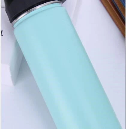 Premium stainless steel insulated tumbler with push-button lid and sleek design for outdoor adventures and active lifestyles.
