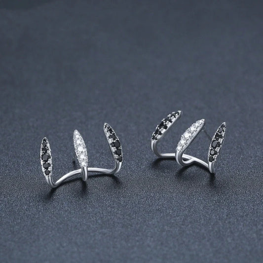 Elegant copper zircon ear clips with a three-claw design, showcasing the natural beauty of the materials and expert craftsmanship
