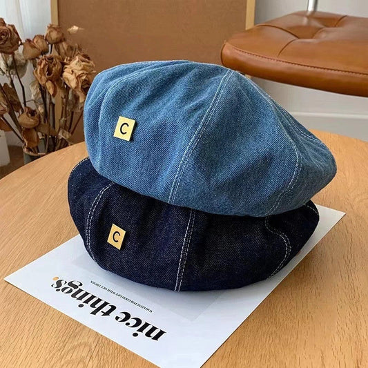 A stylish Japanese-inspired denim beret with a dome-shaped crown and a brimless silhouette, available in light, medium, and dark denim shades.