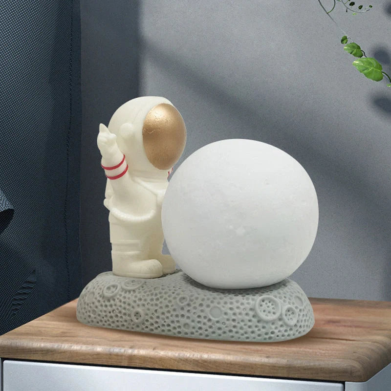 Astronaut-themed colour-changing night lamp with durable natural resin construction