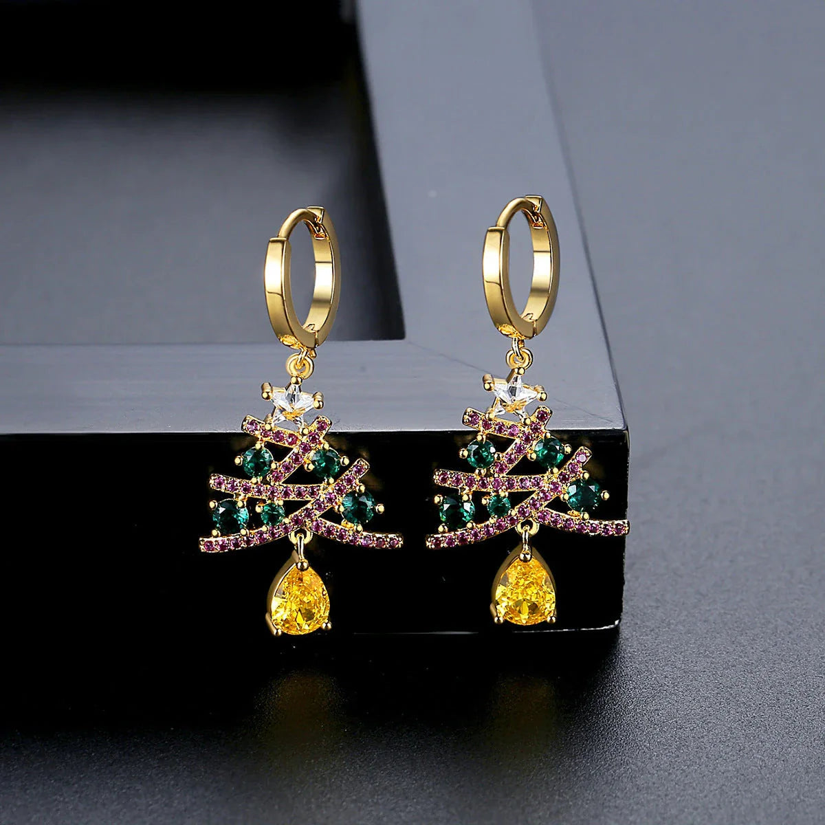 Pair of elegant Christmas tree earrings with a geometric design, sparkling rhinestones, and 18K gold electroplating