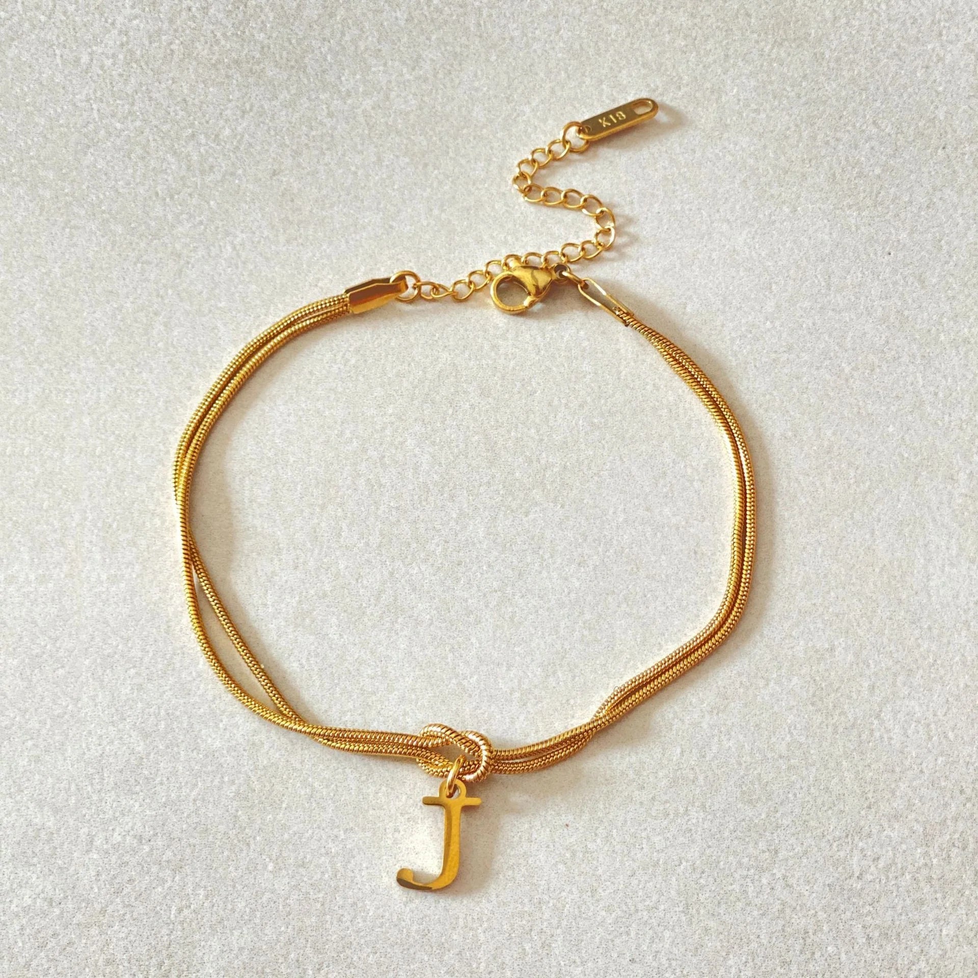 Personalised gold and silver love knot bracelets for couples, perfect as Valentine's Day gifts.