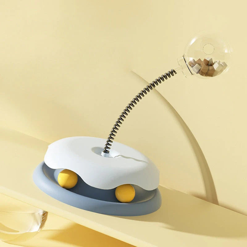 Interactive cat toy with treat dispenser and spring ball in blue, yellow, green