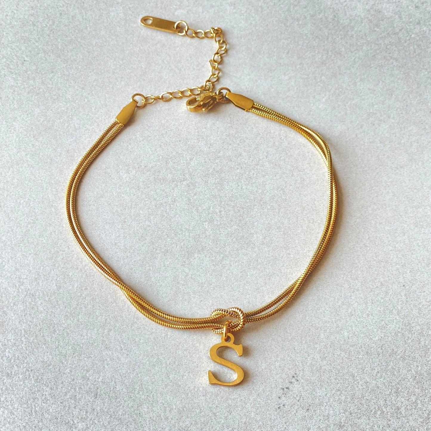 Personalised gold and silver love knot bracelets for couples, perfect as Valentine's Day gifts.