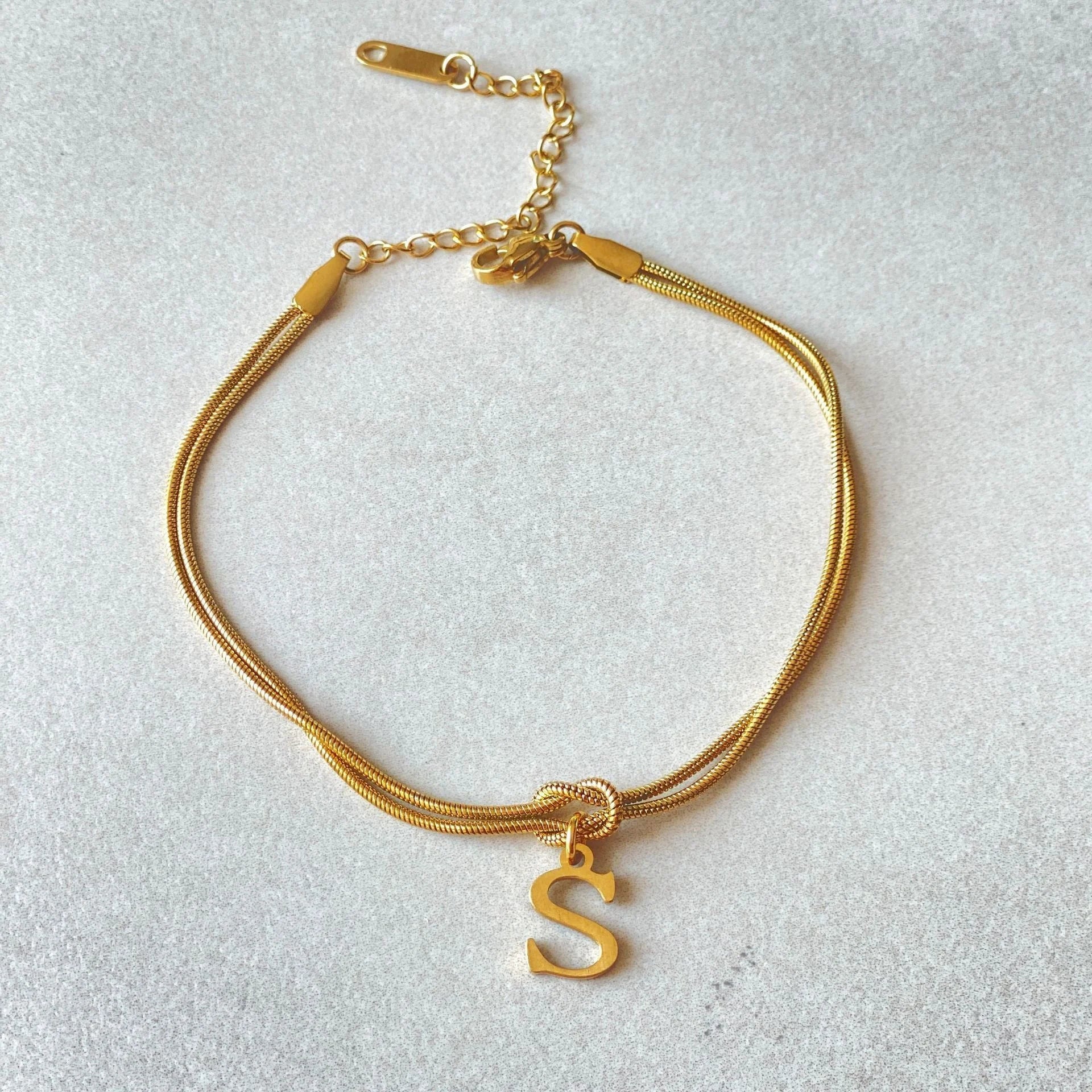 Personalised gold and silver love knot bracelets for couples, perfect as Valentine's Day gifts.