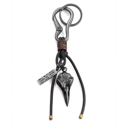 Retro leather keychain with lobster clasp and skull motif in bronze and silver