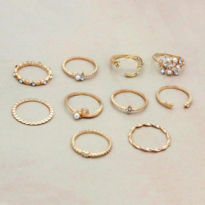 A set of 10 adjustable gold-plated rings with celestial-inspired designs including moons, stars, and pearls