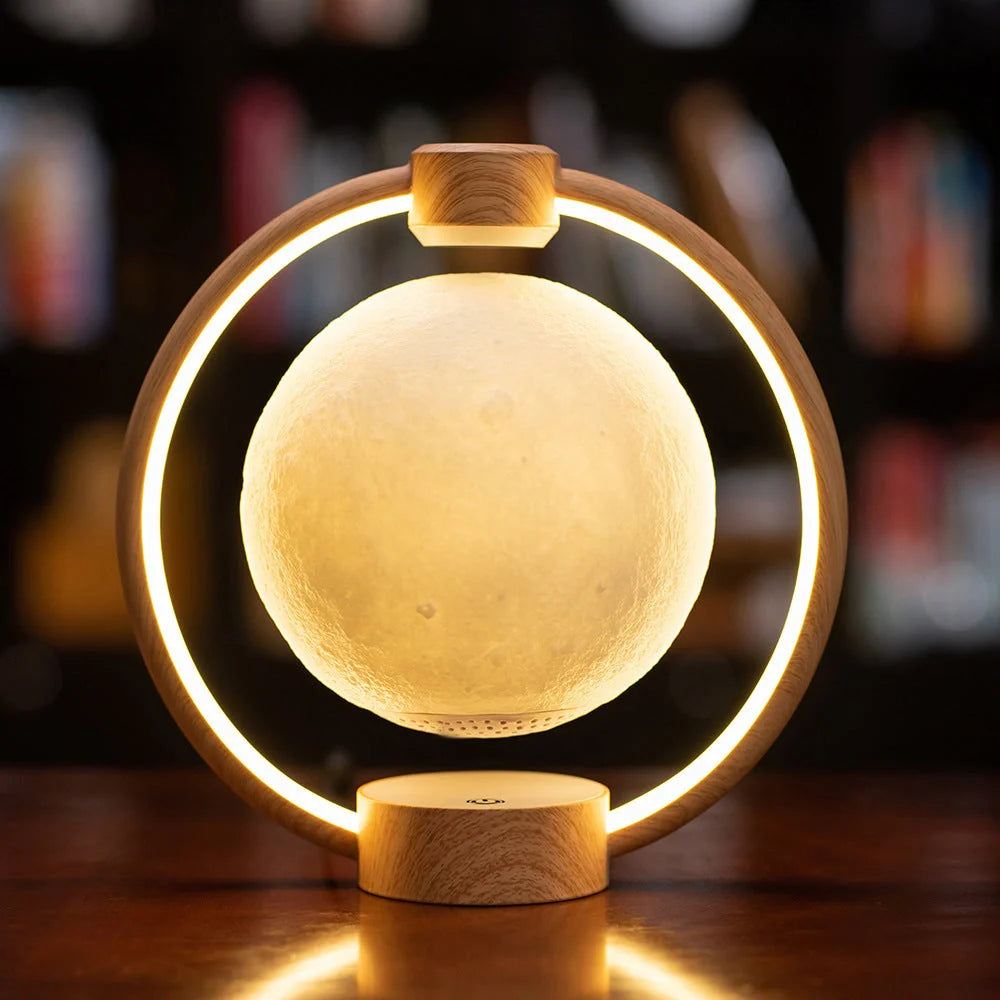 Levitating Bluetooth speaker with moon-shaped orb, colour-changing LED lights, and wooden base