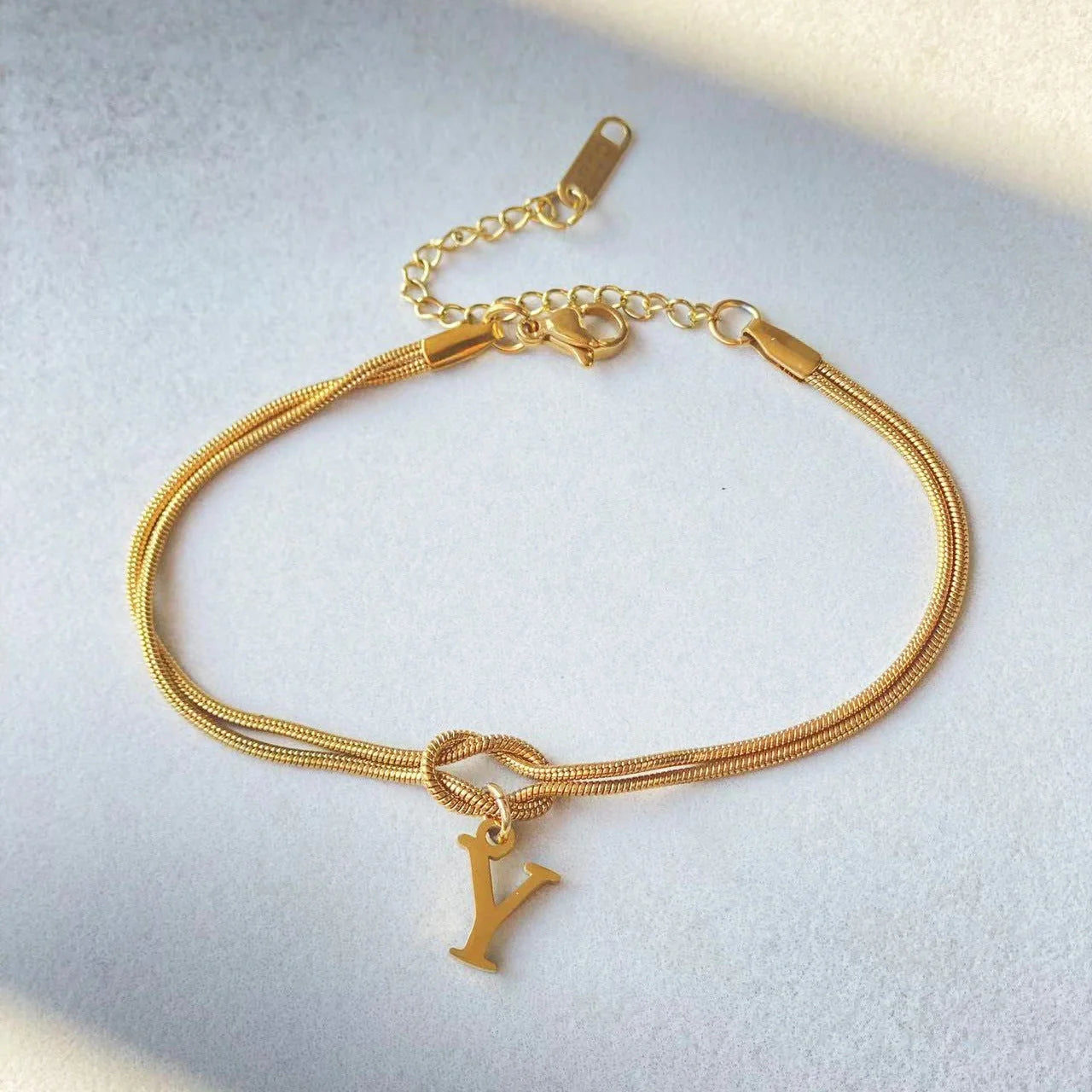 Personalised gold and silver love knot bracelets for couples, perfect as Valentine's Day gifts.