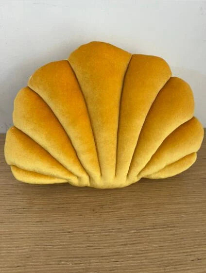 Cosy shell-shaped plush nap pillow in various colours and sizes for ultimate comfort