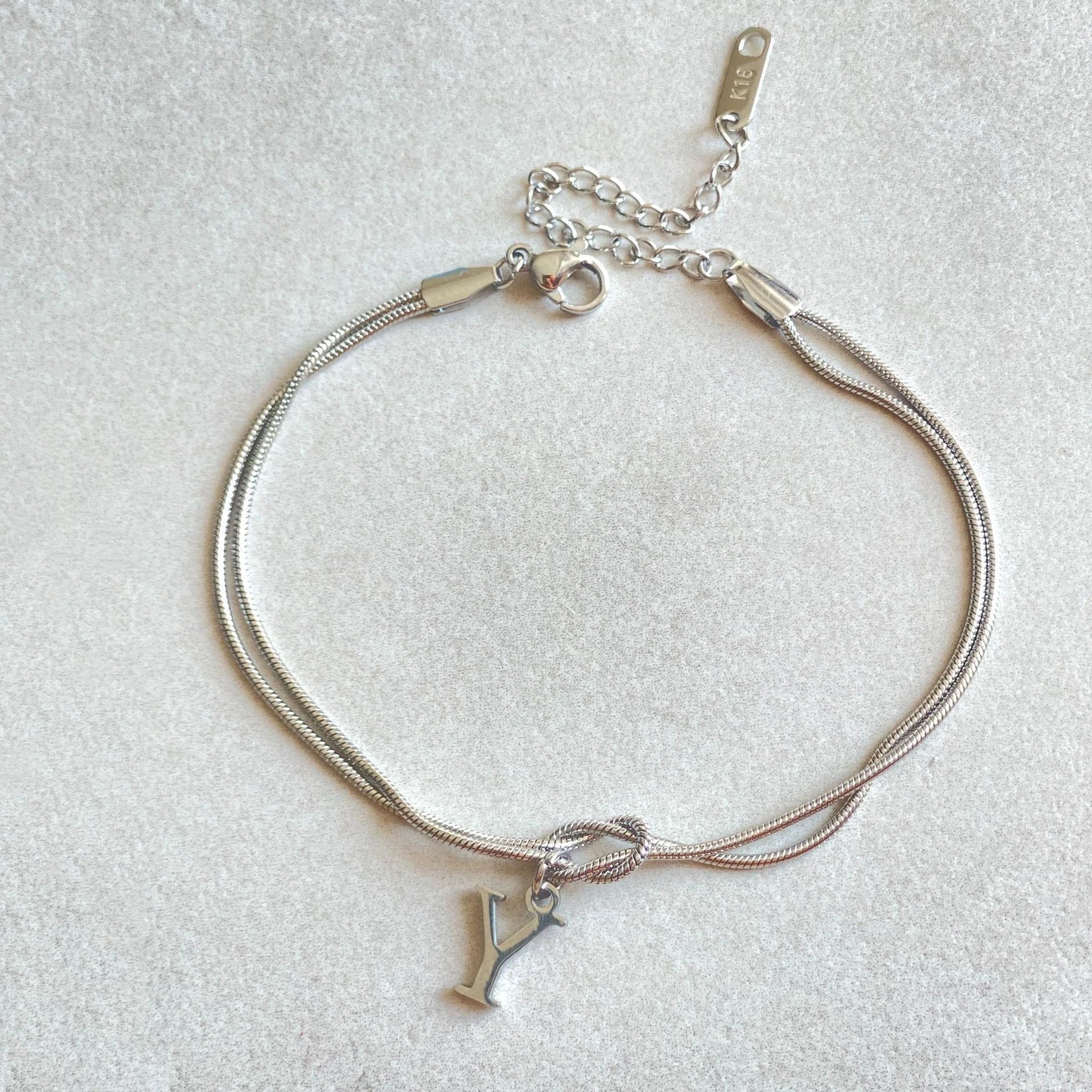 Personalised gold and silver love knot bracelets for couples, perfect as Valentine's Day gifts.