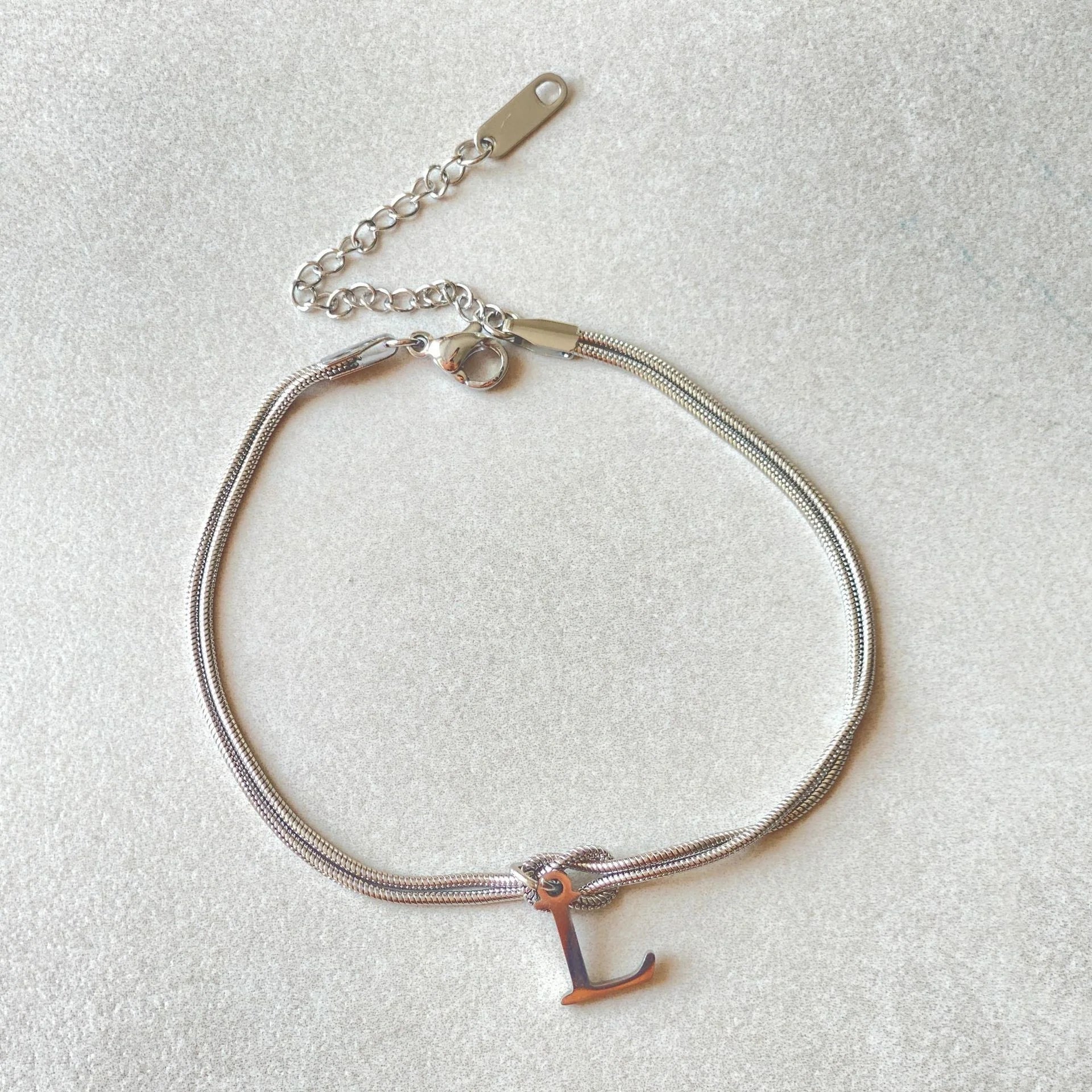 Personalised gold and silver love knot bracelets for couples, perfect as Valentine's Day gifts.