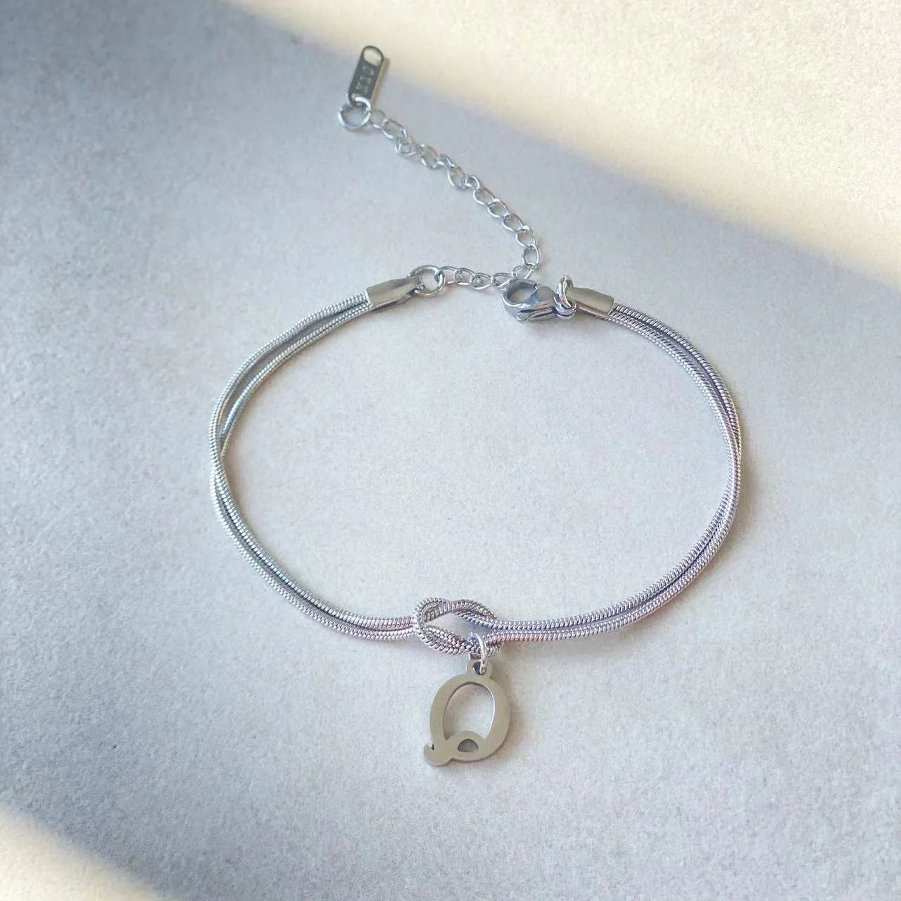 Personalised gold and silver love knot bracelets for couples, perfect as Valentine's Day gifts.
