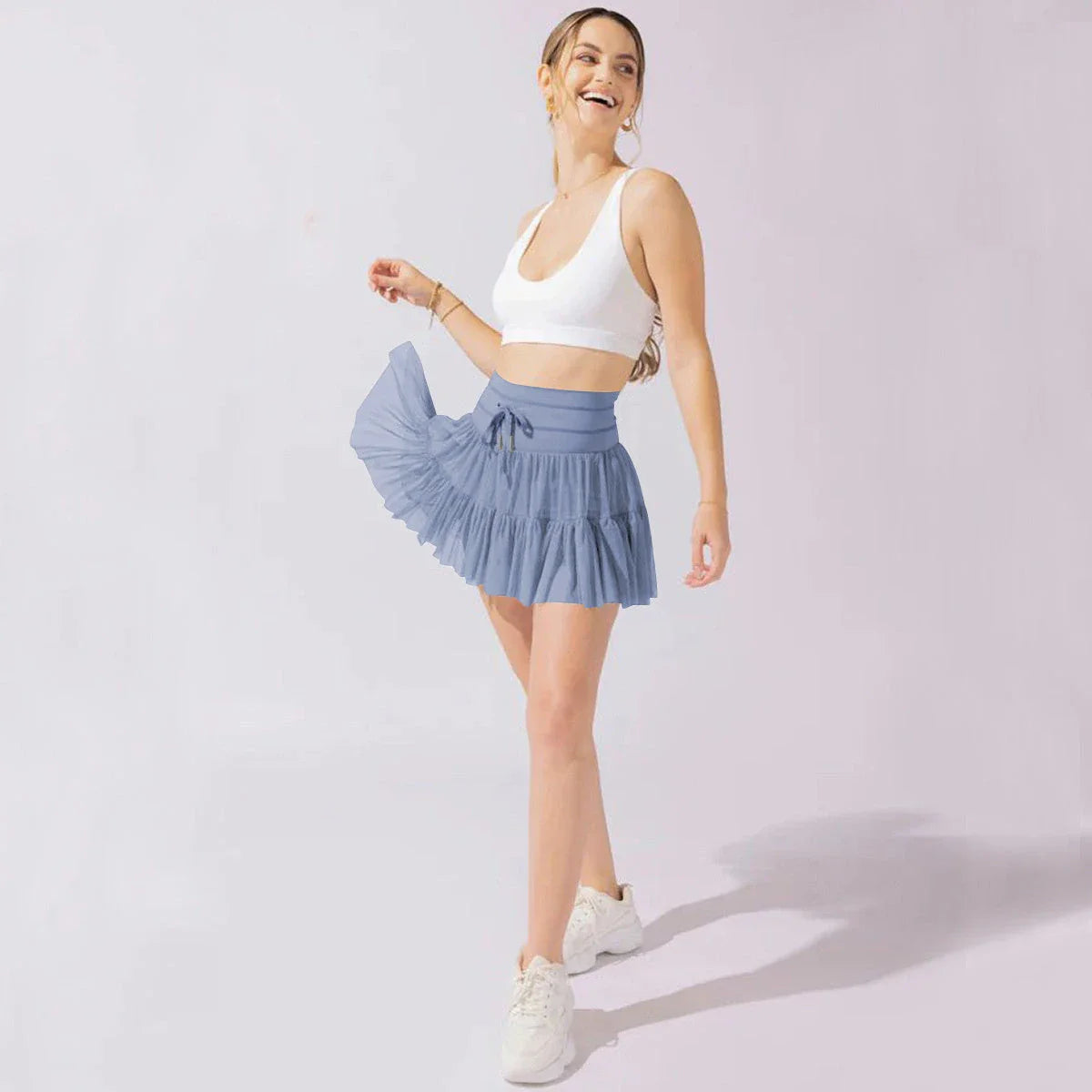 A stylish high-waist lace-up sports skirt with built-in safety shorts in a variety of vibrant colors.
