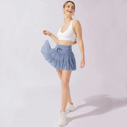 A stylish high-waist lace-up sports skirt with built-in safety shorts in a variety of vibrant colors.