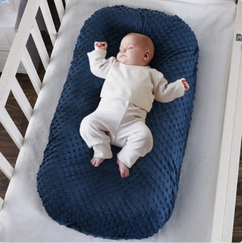 Newborn bionic nap bed in blue and yellow, designed for safety and comfort