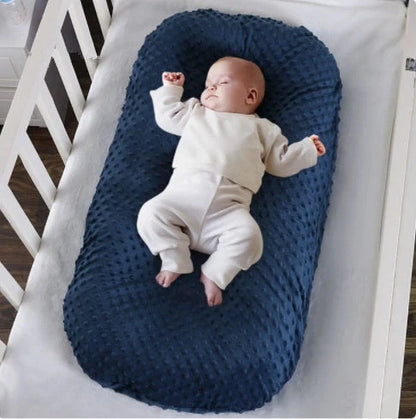 Newborn bionic nap bed in blue and yellow, designed for safety and comfort