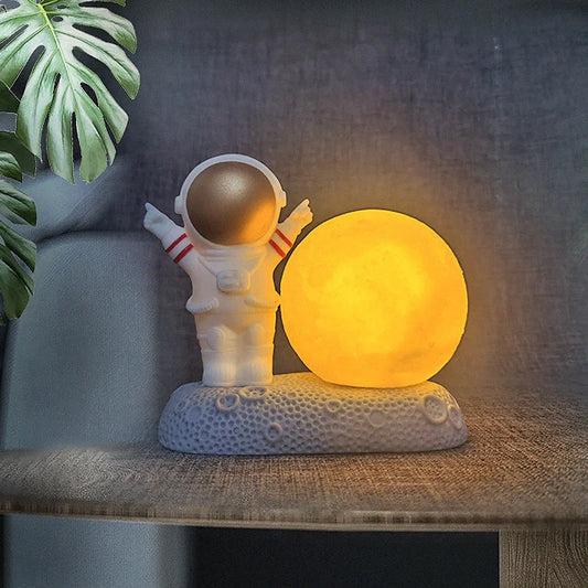 Astronaut-themed colour-changing night lamp with durable natural resin construction