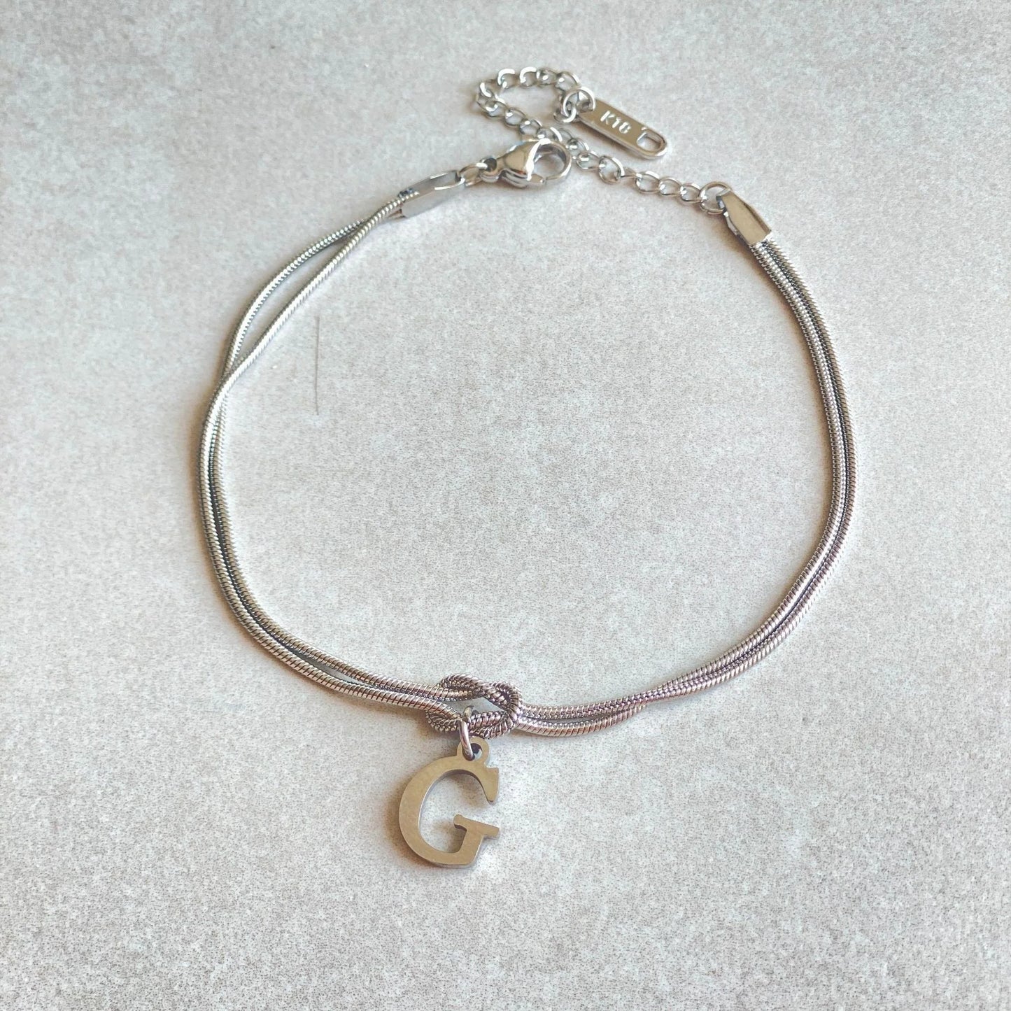 Personalised gold and silver love knot bracelets for couples, perfect as Valentine's Day gifts.