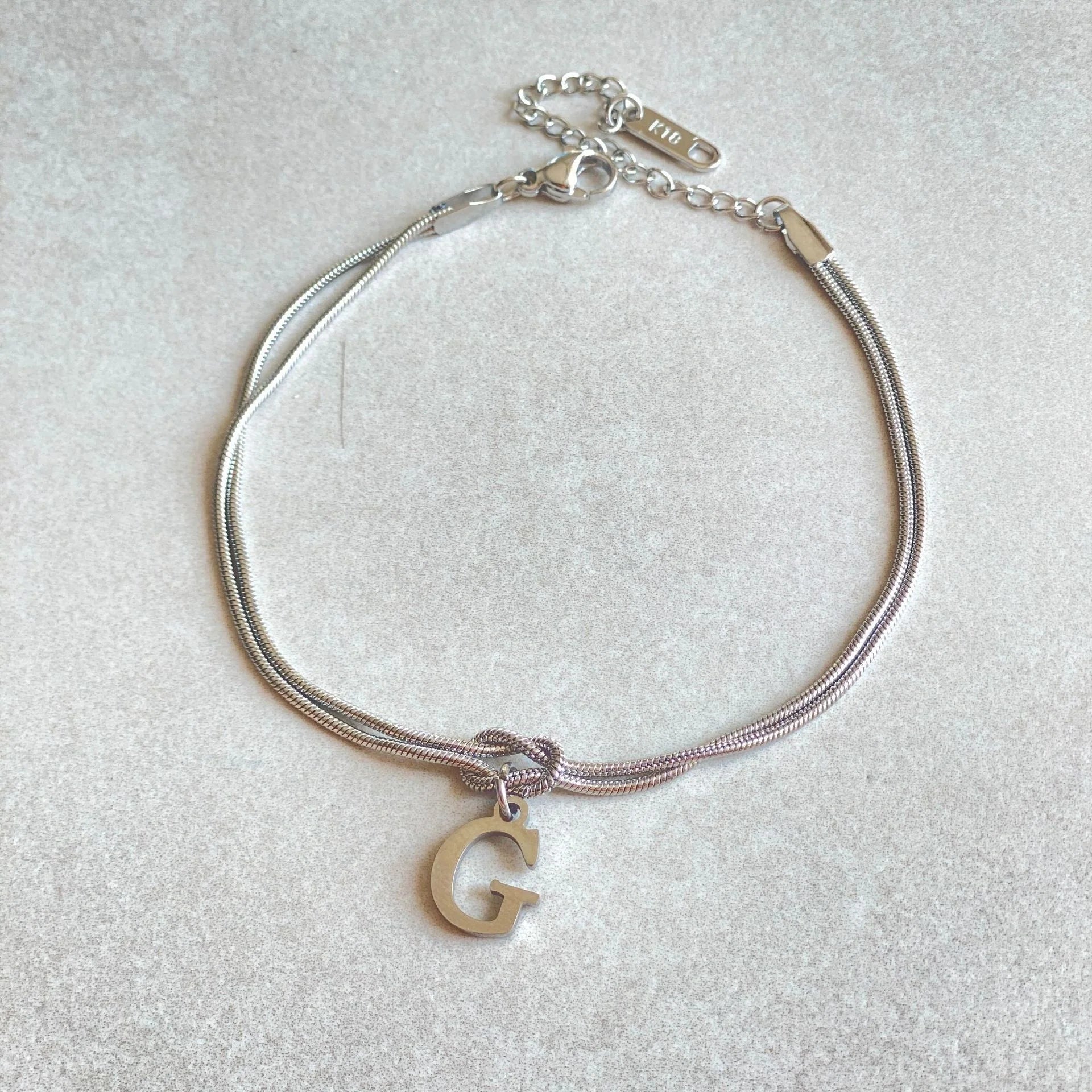 Personalised gold and silver love knot bracelets for couples, perfect as Valentine's Day gifts.