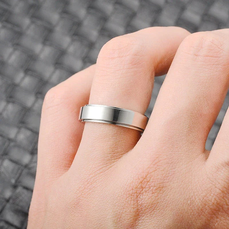 Elegant stainless steel spinner ring with a captivating moon and star design that rotates effortlessly for a calming tactile experience