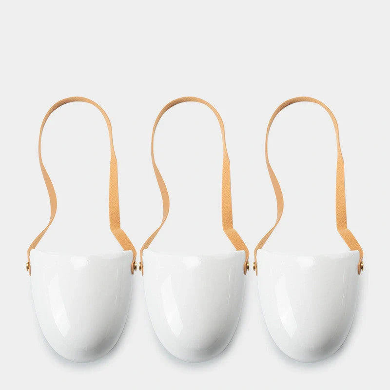 Wall-mounted ceramic flower pot in matte white with hemp rope for balcony gardening