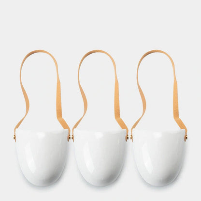 Wall-mounted ceramic flower pot in matte white with hemp rope for balcony gardening