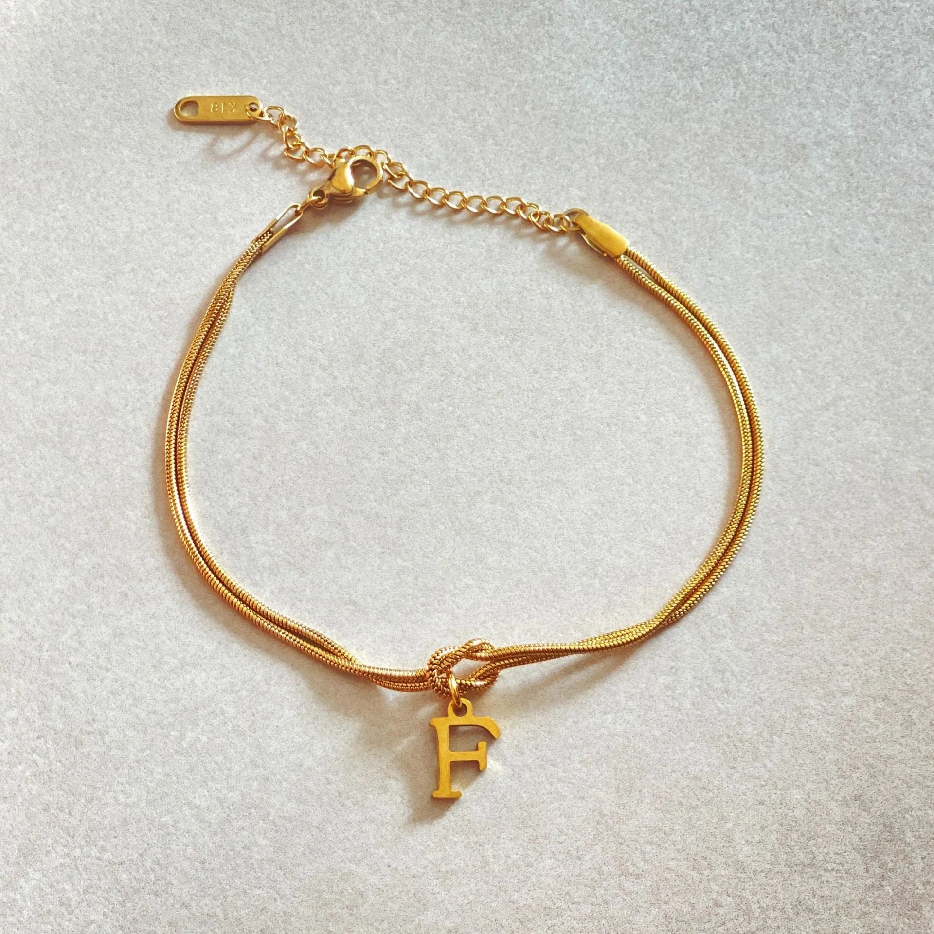 Personalised gold and silver love knot bracelets for couples, perfect as Valentine's Day gifts.