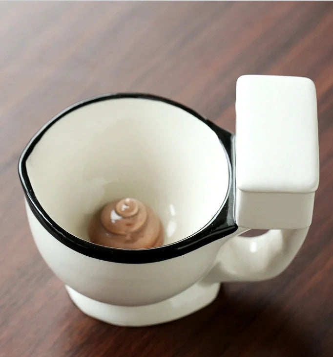 Toilet-shaped ceramic mug with handgrip, perfect for coffee or tea, holding 280ml.