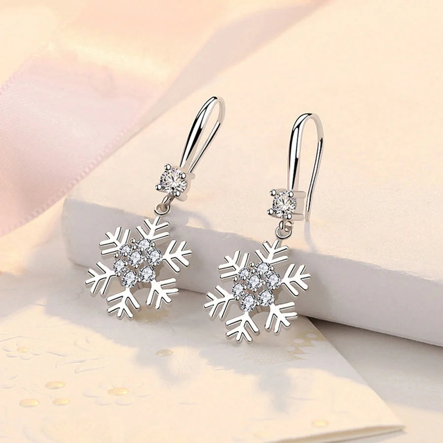 Elegant snowflake earrings with sparkling rhinestones, a festive fashion accessory for women