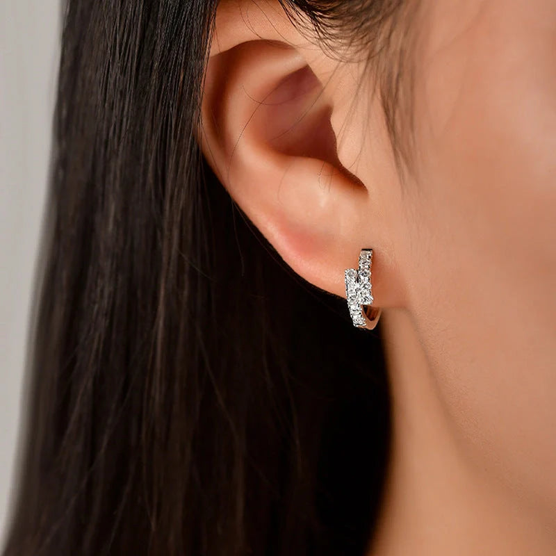 Elegant diamond-accented ear clips with a geometric design, showcasing refined British style.