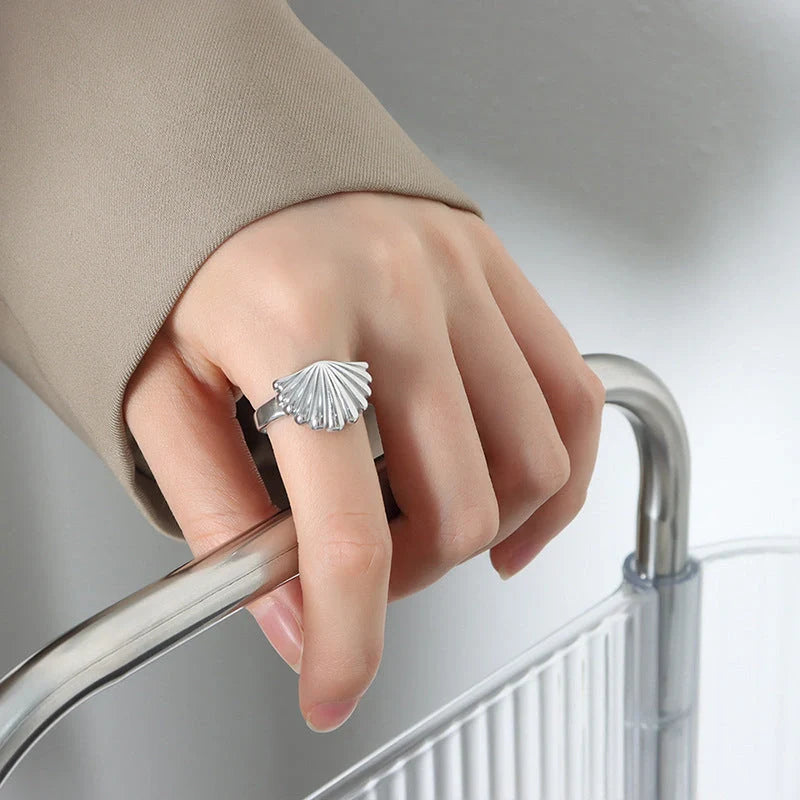 Ocean Style Scallop Ring in titanium steel and gold finishes, showcasing geometric design inspired by the sea.