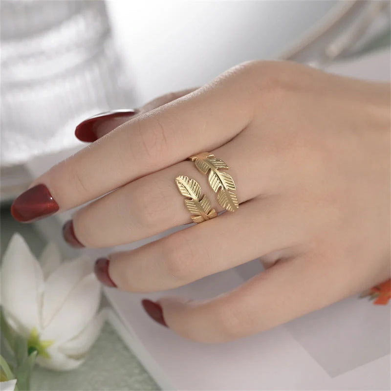 Feather-themed titanium steel open ring in gold and silver colours, with an adjustable design and elegant geometric shape