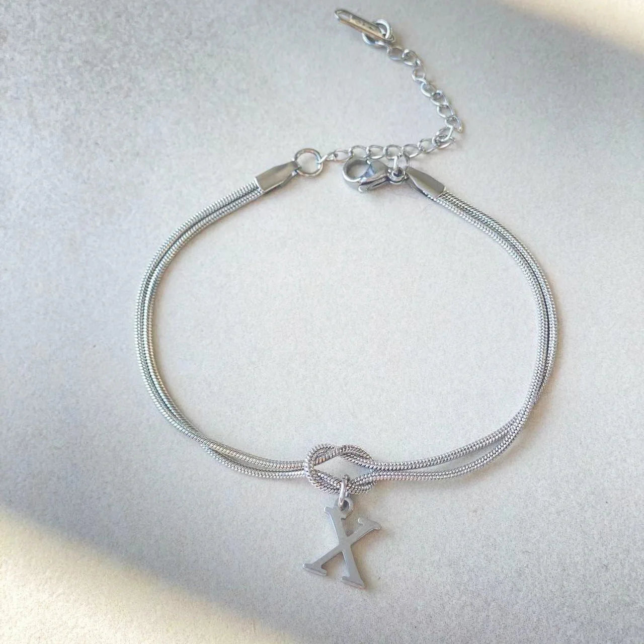 Personalised gold and silver love knot bracelets for couples, perfect as Valentine's Day gifts.