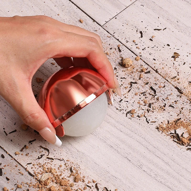 Reusable hair remover ball in liquid silver and rose gold colors, designed to remove pet hair, lint, and dust from clothes, furniture, and more