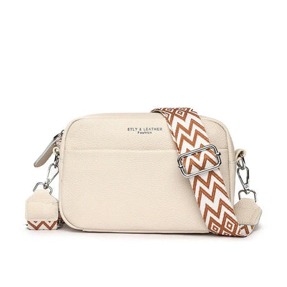 A fashionable crossbody bag with a rhombus embroidered strap, available in multiple colors including black, beige, green, blue, and khaki.