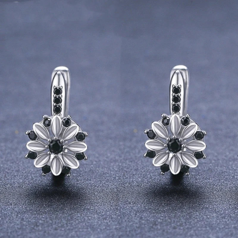 Elegant copper flower earrings with sparkling zircon accents, perfect for any occasion.