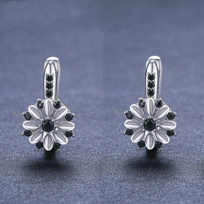 Elegant copper flower earrings with sparkling zircon accents, perfect for any occasion.