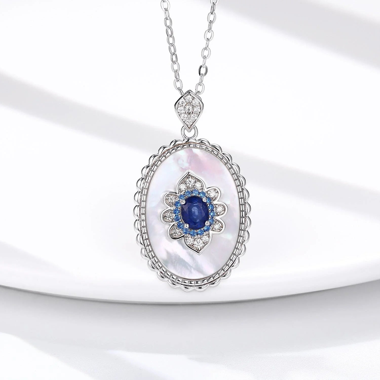Elegant sterling silver pendant necklace with sparkling sapphires and diamonds, perfect for fashion-forward women