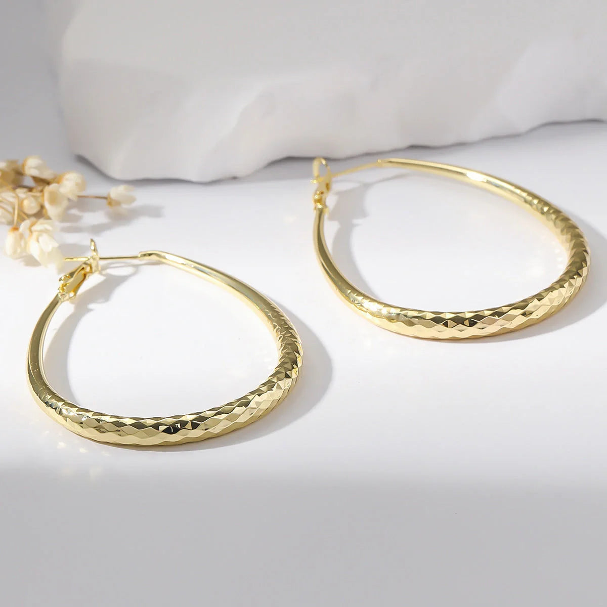 Golden egg-shaped hypoallergenic copper earrings with spring fastener