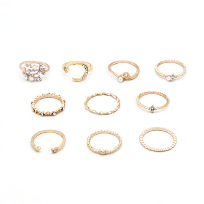 A set of 10 adjustable gold-plated rings with celestial-inspired designs including moons, stars, and pearls