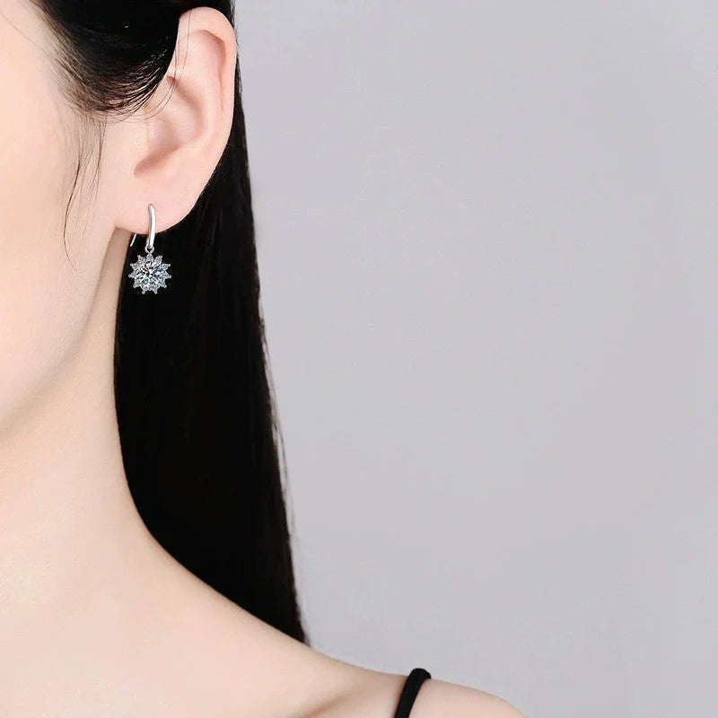 A pair of elegant sunflower-shaped ear studs in a gleaming white gold tone, showcasing the intricate floral design and premium craftsmanship.